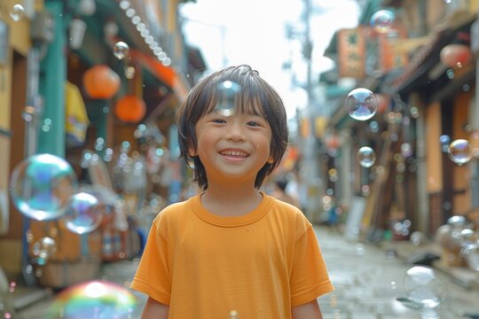 A young boy in an orange shirt, smiling amidst soap bubbles on a lively street.
