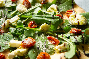Salad pizza topped with various vegetables	