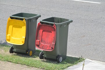 Two empty rubbish and recycling bins on residential city street