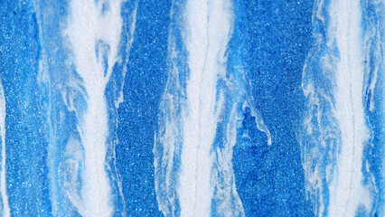 Paint drip. Glitter fluid spill. Defocused blue white color metallic shimmering texture acrylic ink...