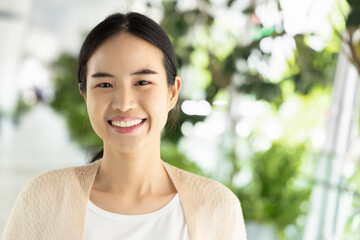 Happy, smiling, friendly asian woman in casual dress, showing positive facial expression.