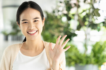Happy, smiling, friendly asian woman in pointing up 5 fingers, concept image for number five, five...