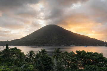 View of the bay and Gunung Api volcano in Naira island, Banda islands, Maluku at sunset