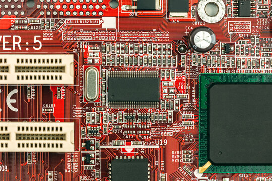 red circuit board background with chips, sockets and electronic components.