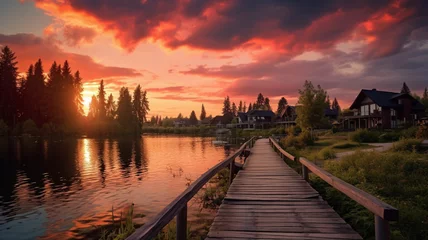 Schilderijen op glas Sunset over the lake in the village landscape © BornHappy