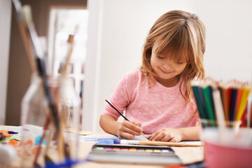 Happy child, writing and drawing with color for creativity, learning or education at home. Young girl with color pencil for sketching, activity or artwork in early childhood development at the house