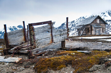 Mining relics in front of miners cottage on Svalbard Archipelago