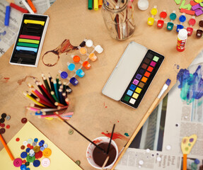 Paint, color and stationery with supplies for drawing, sketching or arts and crafts on table above....