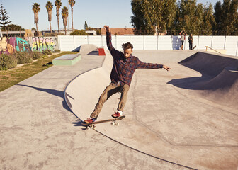 Fitness, sports and man with skateboard, jump or ramp action at a skate park for stunt training....