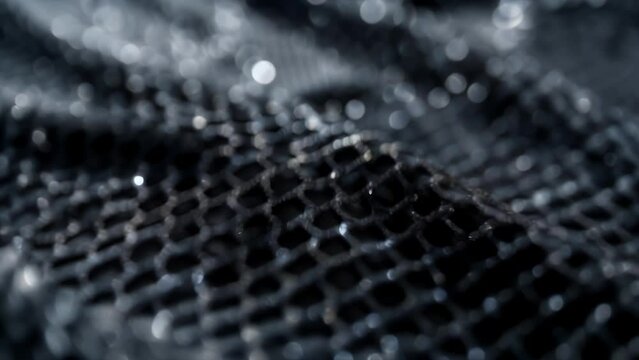Detailed shot of a specialized mesh material inspired by the beetles bumpy surface used to and absorb water droplets in arid regions.