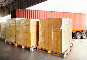 Package Boxes Wrapped Plastic Stacked on Pallets. Trucks Loading at Warehouse Dock. Cargo...