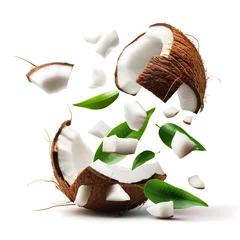Tapeten Fresh Coconut with Leaves Exploding into Pieces on White Background © slonme
