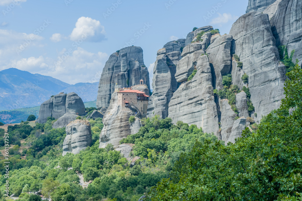 Wall mural expansive view of monastery on a cliff with a wild, mountainous backdrop, in meteora, greece