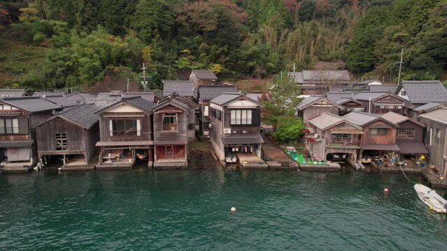 Drone Slow Motion Fly Above Boathouses Ine-Cho, Japan Kyotango Village Blue Sea Aerial Panoramic of Traditional Wooden Homes