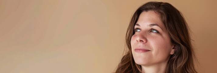 Woman portrait in her mid thirties isolated from a beige copyspace background