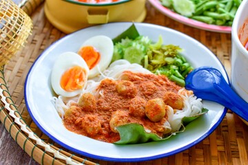 Kkanomjeen namya krati Rice vermicelli with minced fishes and coconut milk  in red curry and boiled eggs