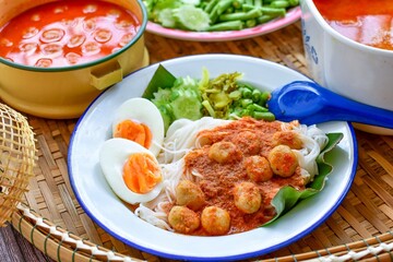 Kkanomjeen namya krati Rice vermicelli with minced fishes and coconut milk  in red curry and boiled eggs