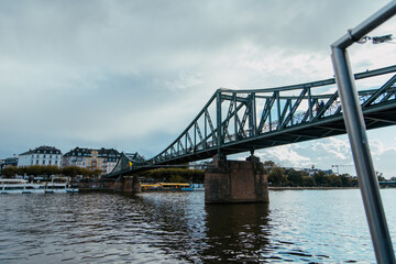 Fototapeta na wymiar Iron Bridge over main river Frankfurt Germany