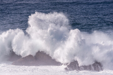 Spectacularly big waves from the pacific ocean smash into the californian coast along US highway 1.