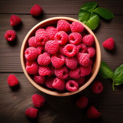 Organic, natural, fresh and healthy red raspberries in a fruit bowl, wooden fruit background 