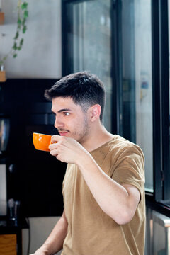 young white barista drinks a latte in the morning