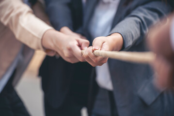 Tug of war Businesswoman Team holding hands together partnership leader teamwork. Group of business people Hands pulling rope symbol team unified teamwork Partnership Concept. diversity competition - obrazy, fototapety, plakaty