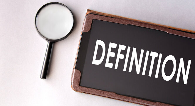 DEFINITION - word in electronic notebook on white background with magnifying glass