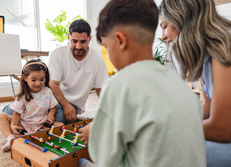 Family Enjoying Table Soccer Game at Home