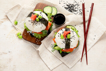 Hybrid modern food. Sushi burger with salmon, white rice, avocado, cucumber.