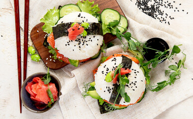 Hybrid modern food. Sushi burger with salmon, white rice, avocado, cucumber.