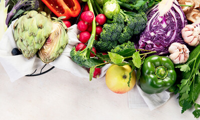 Table with vegetables on a light wood background. Pepper, cabbage, broccoli, radish, garlic....