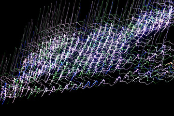 Abstract patterns of Christmas holiday lights against a black background, appearing to move and dance