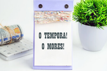 o tempora, o mores (O, the times O, the morals) Latin phrase on a piece of a desktop calendar with tear-off pages - obrazy, fototapety, plakaty
