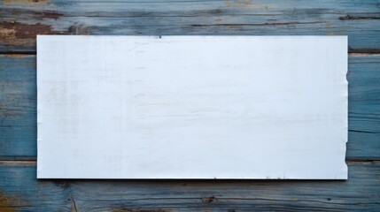 Blank paper sheet on old blue wooden wall.