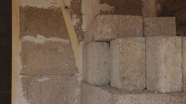 Hempcrete bricks and wall interior in a construction site, panning left to right