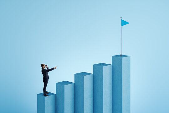 Businessman with binoculars pointing at blue business chart top with flag on white background. Success, financial growth and strategy concept.