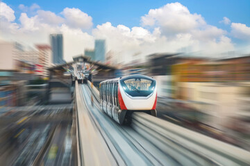 High speed monorail train with bright headlights passes race station on the stage through a tunnel at a road junction around metropolis cityscape urban scape