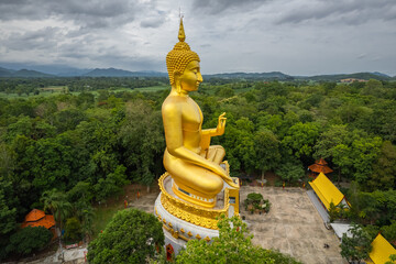 Fototapeta na wymiar Big Gold Buddha statue at Wat Pha Thang, Uthai Thani, Thailand