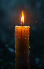 Single burning candle is seen in the dark with water droplets on it