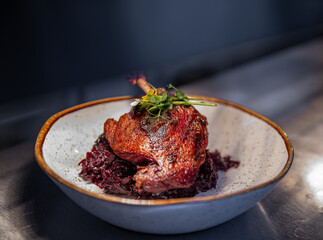 Roast duck leg served with red cabbage