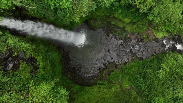 Tiu Teja Waterfall zooming out in aerial view on Lombok, Indonesia.