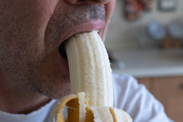 Detail of a Boy's Mouth Biting a Banana