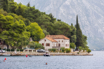Fototapeta na wymiar Perast, Montenegro houses on promenade of the ancient town and mountains panorama