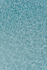 Beautiful view of swimming pool surface with clear blue water with sunlight reflections on wave....