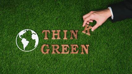 Hand arrange wooden alphabet in ecological awareness campaign with ECO icon design on biophilia green grass background to promote environmental protection for greener and sustainable future. Gyre - obrazy, fototapety, plakaty