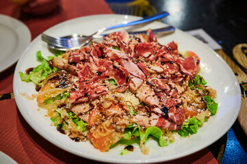 Healthy salad with lettuce, tomato ham and sesame seeds