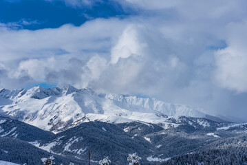 Obraz premium Beautiful landscape of the Arkhyz ski resort with mountains, snow, forest on sunny winter day. Caucasus Mountains, Russia.