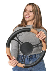 Caucasian blonde with steering wheel, playfully mimicking driving .