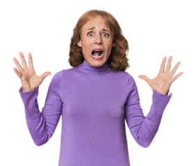 Redhead mid-aged Caucasian woman in studio screaming to the sky, looking up, frustrated.