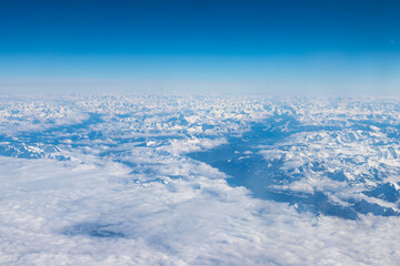 An aerial view of the Alps, a European mountain range and also the highest and most extensive mountain range that is entirely in Europe, stretching approximately 1,200 km across eight Alpine countries